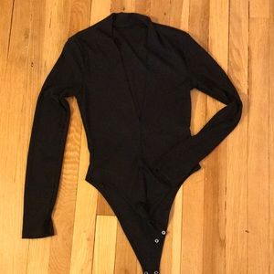 Deep V-neck, ribbed, long sleeve black bodysuit